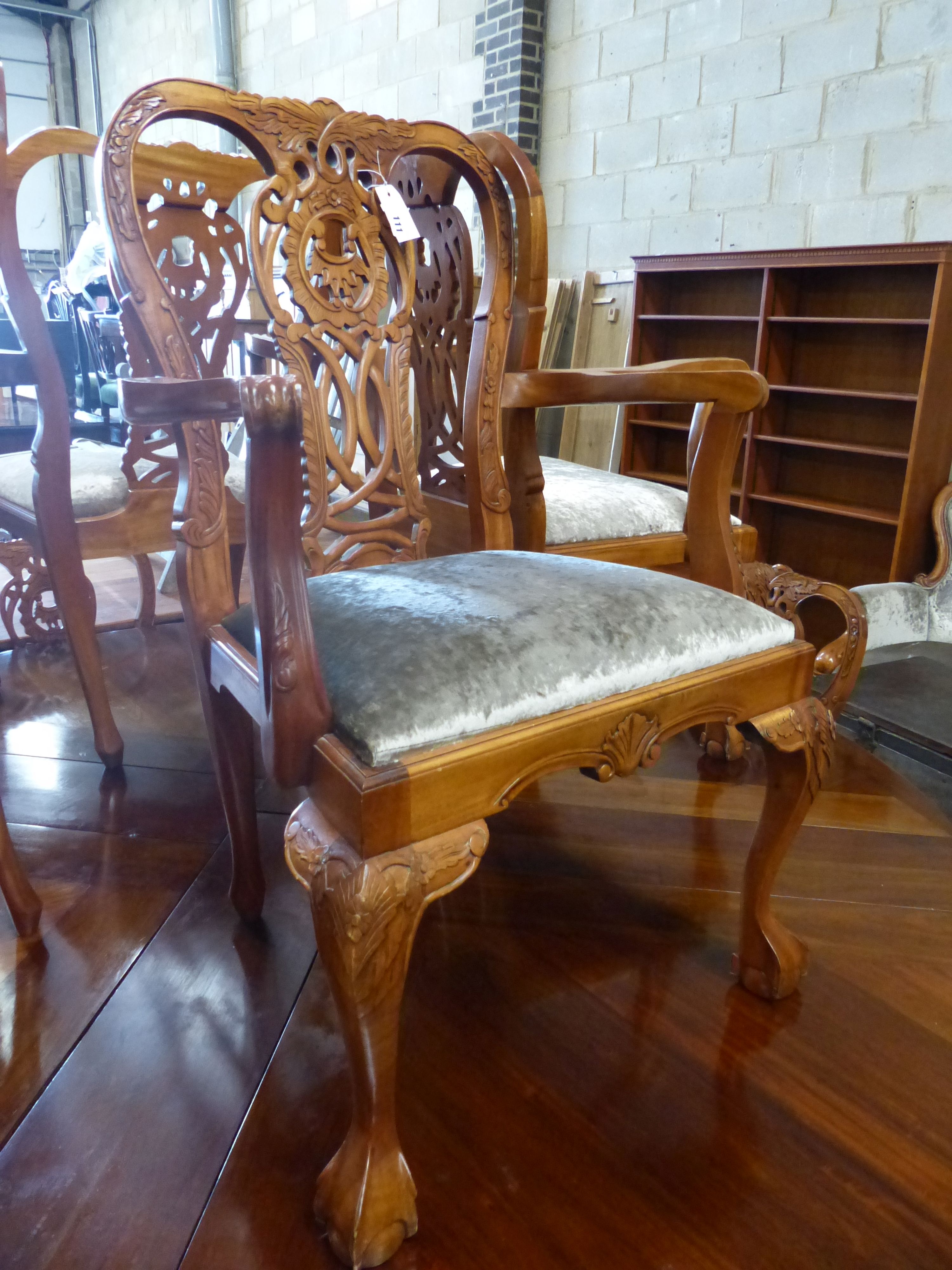 A set of twelve Chippendale style mahogany dining chairs, four with arms